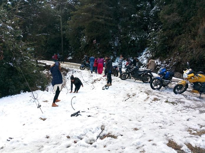 People playing with snow at Daman of Thaha Municipality, on Saturday.